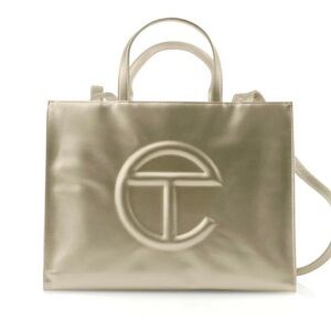 Gold Medium Telfar bag. Used. Scratches shown in picture. Comes with dust bag.